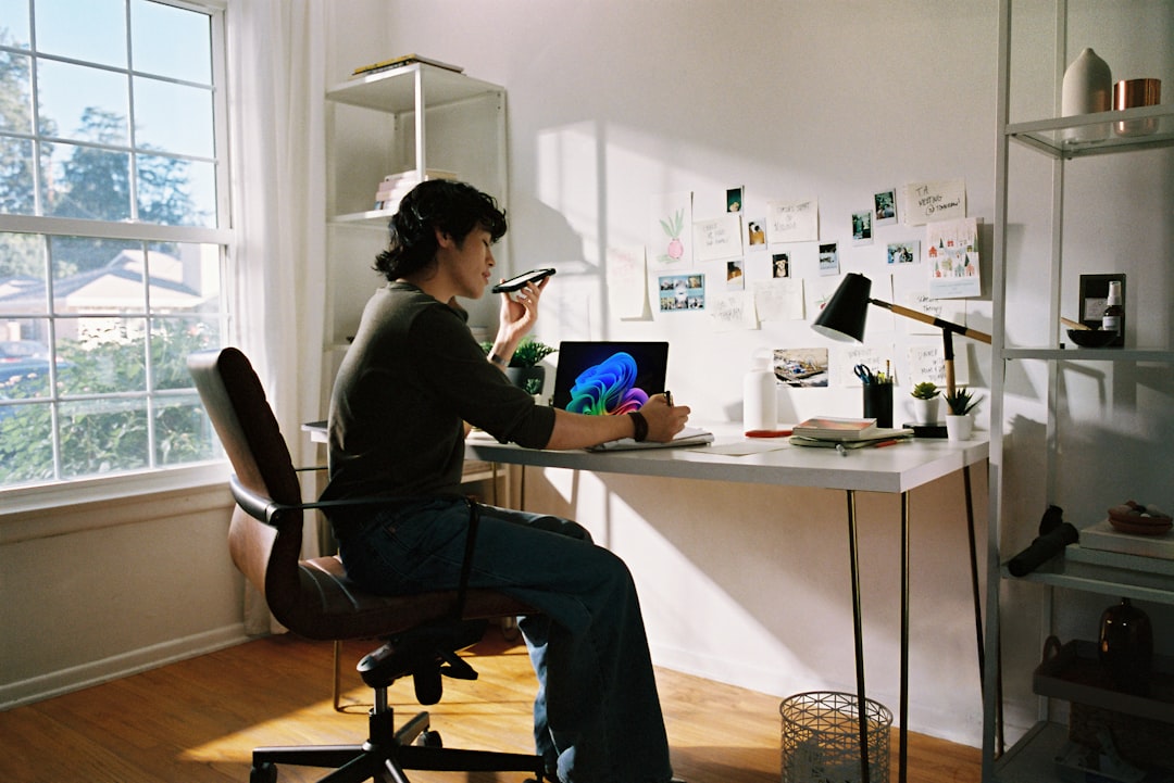 A person sits at a clean, modern desk reviewing financial documents with a calculator and a set of house keys, symbolizing the costs of selling a home.