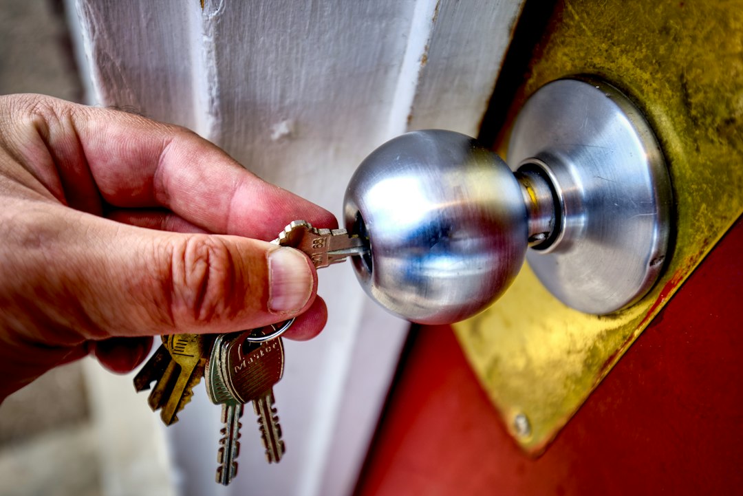 A person's hand holds two distinct keys, one modern and one traditional, symbolizing the choice between different real estate fee structures.